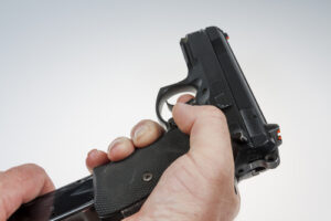 Man loading a clip into a pistol