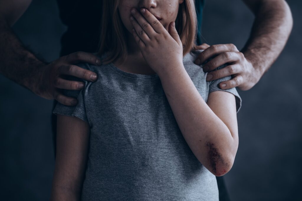 adult man threatening young girl
