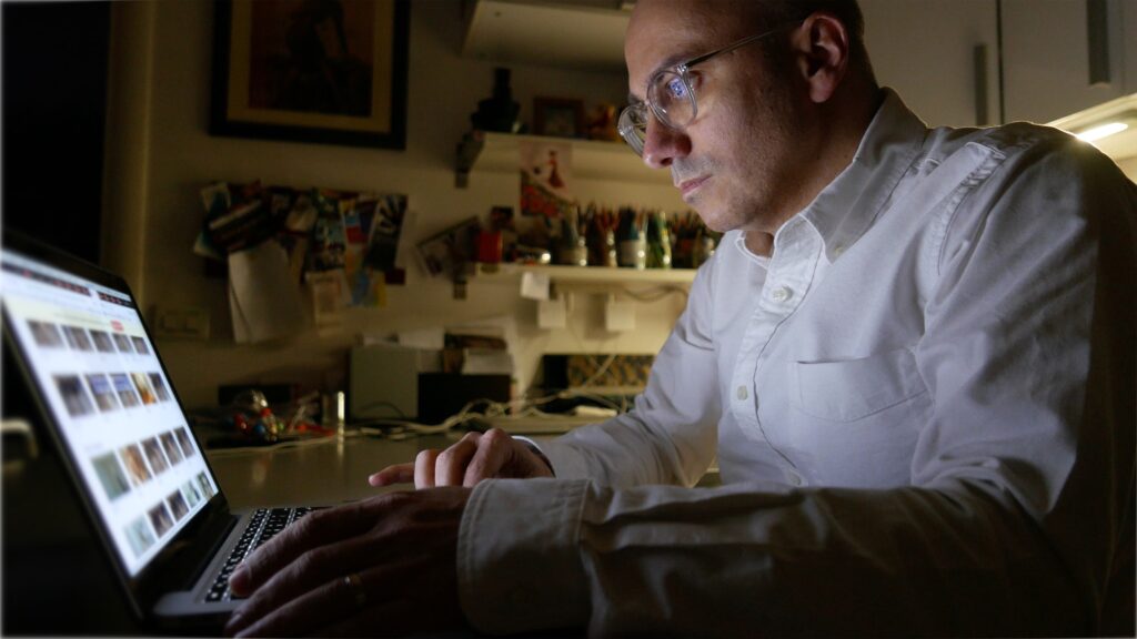 Man watching child pornography at night.
