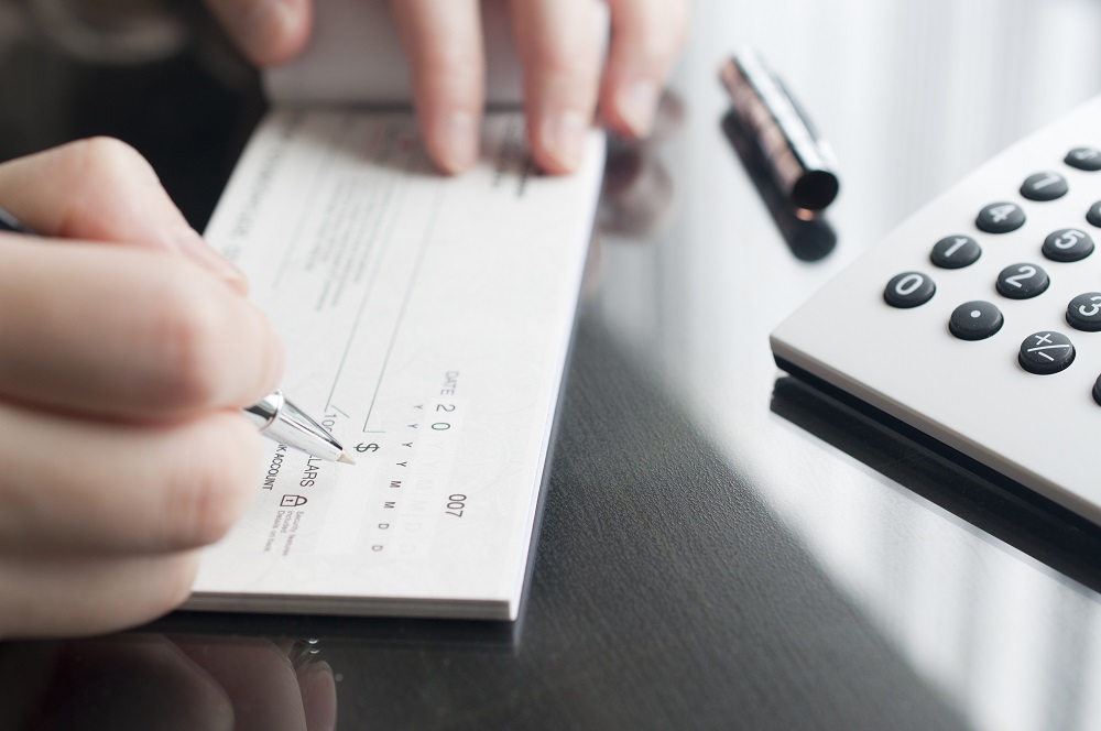 Businessman writing out a check.