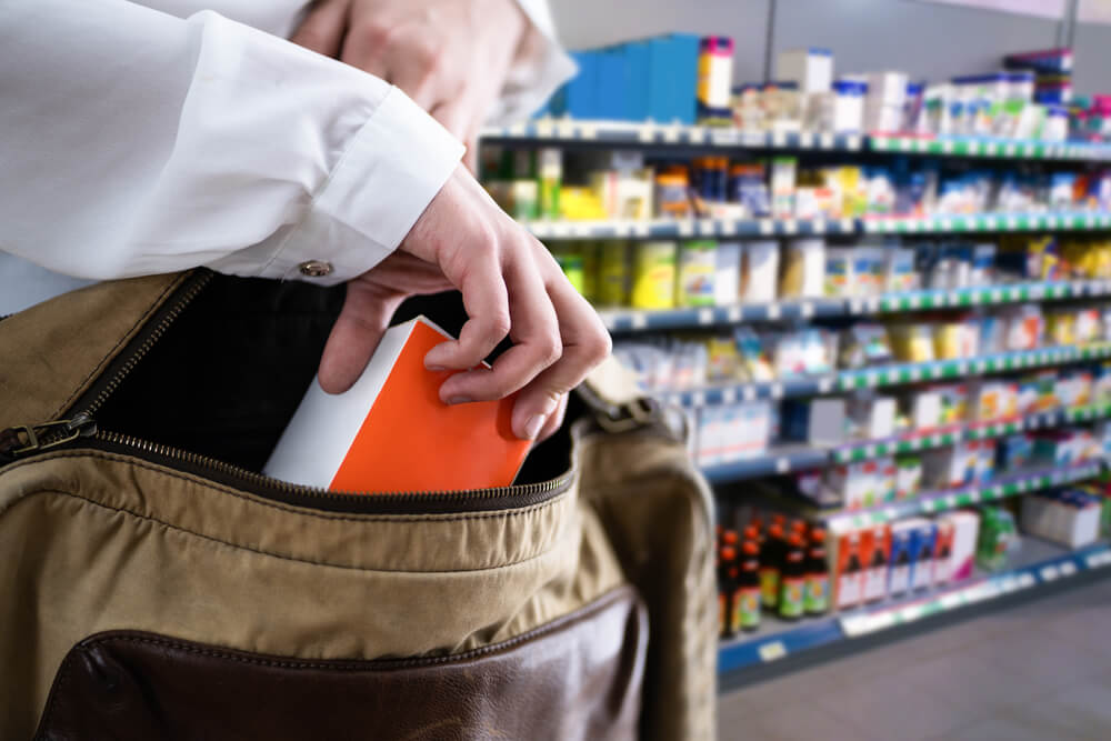Woman shoplifting gadget.