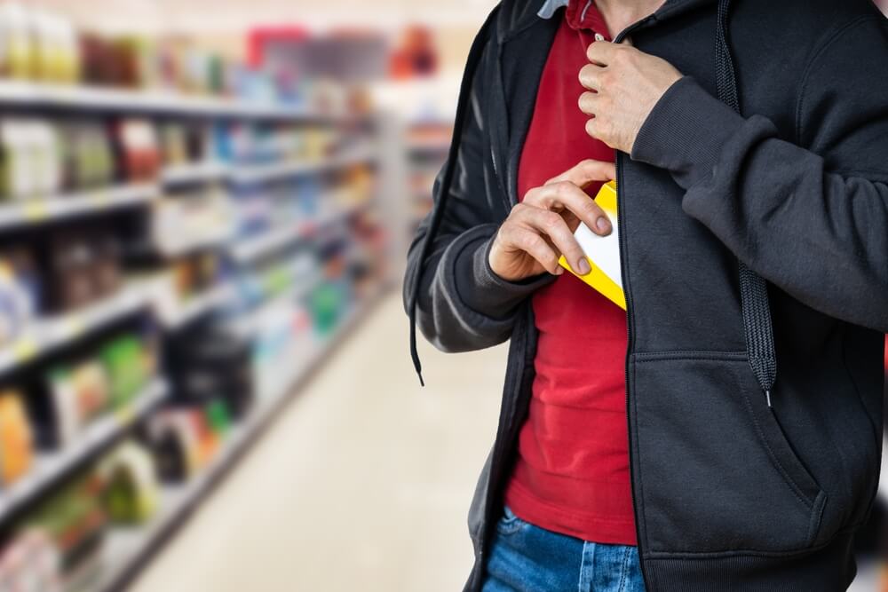 Man shoplifting gadget in the store.