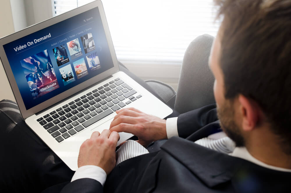 Man watching videos on his laptop.