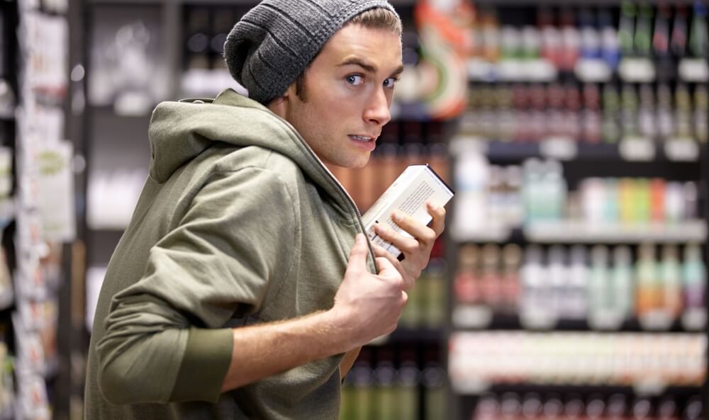Man stealing expensive food in the grocery store.