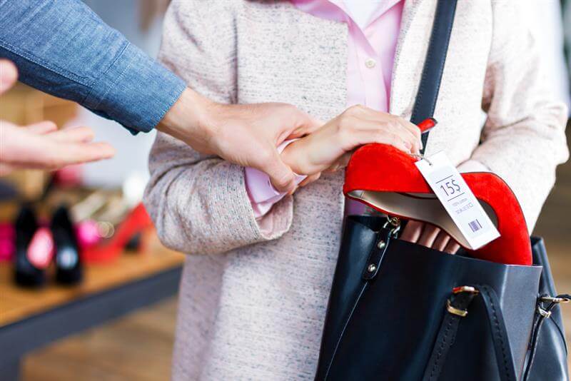 Shoplifter caught stealing the red shoes.