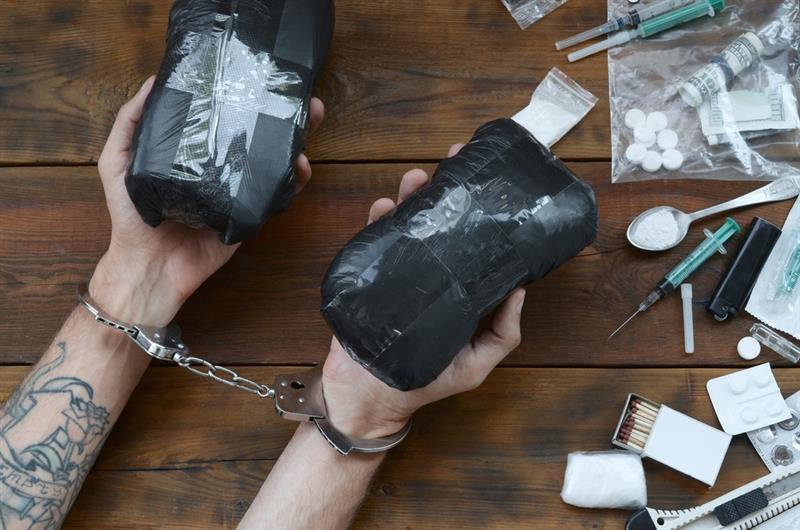 Drug trafficker arrested with their heroin packages.
